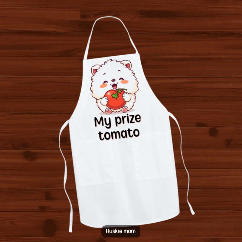 Funny apron featuring a fluffy animal contentedly patting a tomato, combining kitchen practicality with garden humor.