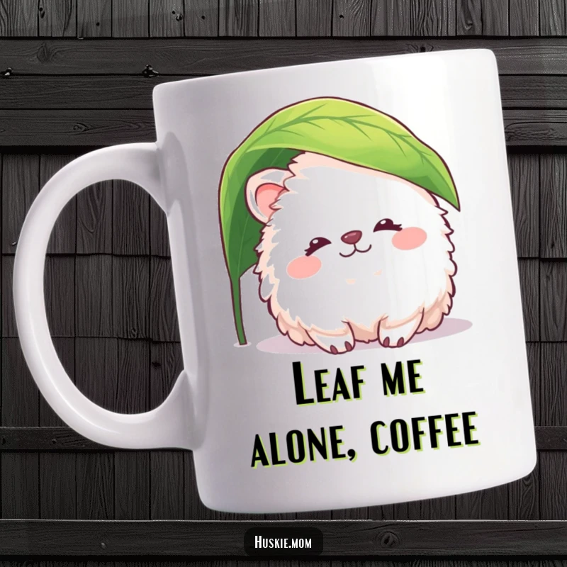 Funny fluffy animal mug featuring a creature with a peaceful smile peeking from under a leaf, evoking gentle humor and serenity.
