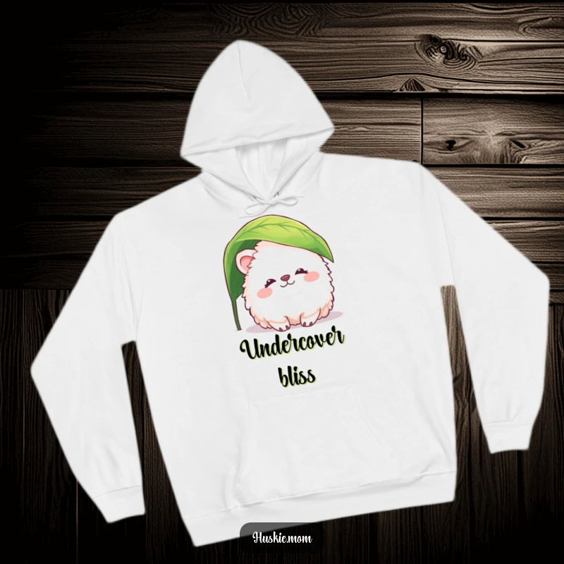 Funny fluffy animal hoodie featuring a peaceful creature peeking from under a leaf, offering cozy comfort and gentle humor.