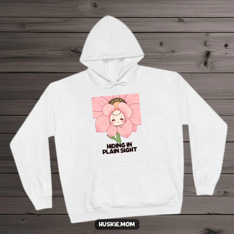 Funny hooded sweatshirt with a shy character peeking from behind a large flower, a sweet and bashful grin on its face, offering warmth and humor.
