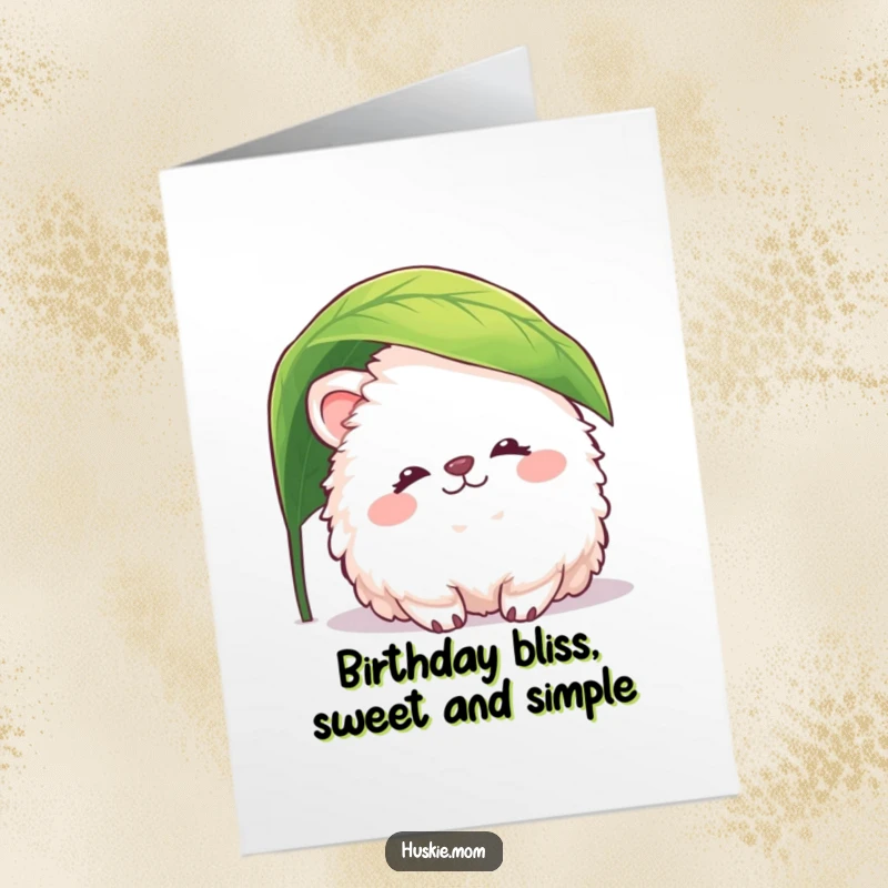 Funny Free Printable Birthday Card: Fluffy animal with peaceful smile peeking from under a leaf, perfect humorous downloadable gift.
