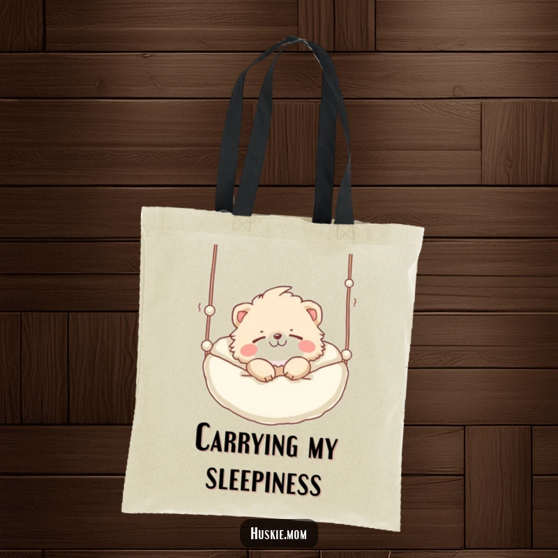 Funny Tote Bag: A cute fluffy animal with a playful grin sleeping soundly in a suspended bed, perfect for carrying nap necessities.